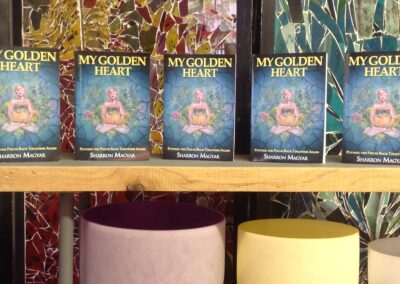 My Golden Heart books on shelf above colorful bowls