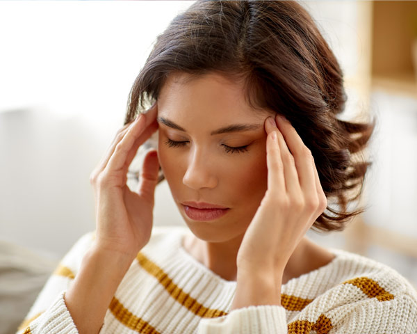 Woman with eyes closed dealing with stress